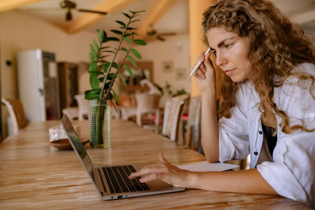 woman working on a computer at a desk 