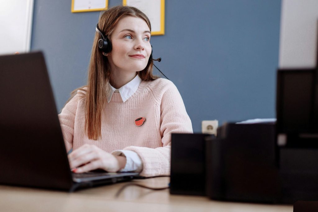 woman wearing headphones working at a computer 