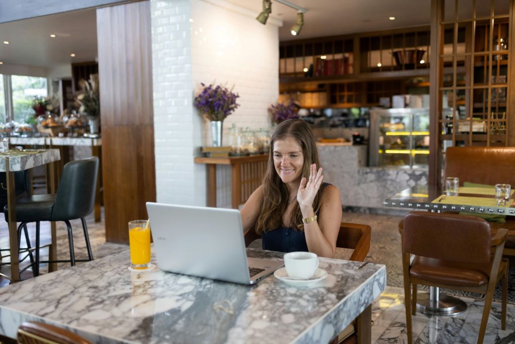 online tutor sitting at a laptop computer