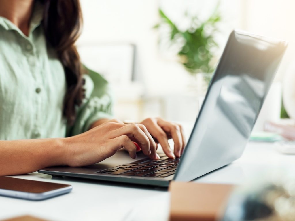woman typing on laptop