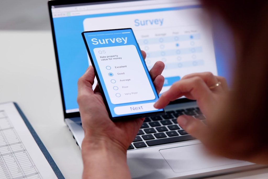 person filling in online survey on smartphone