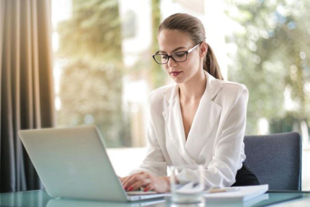 woman sitting at a computer typing 