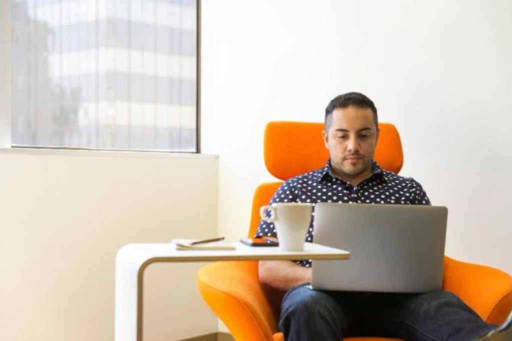 man sitting doing data entry on a computer 