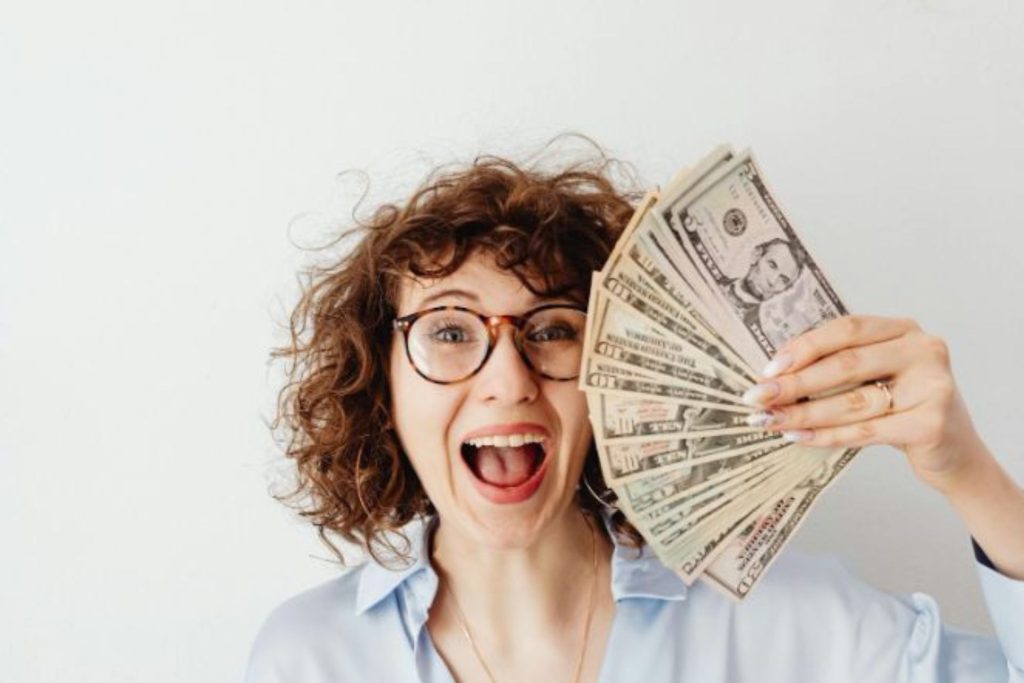 woman holding money in her hand 
