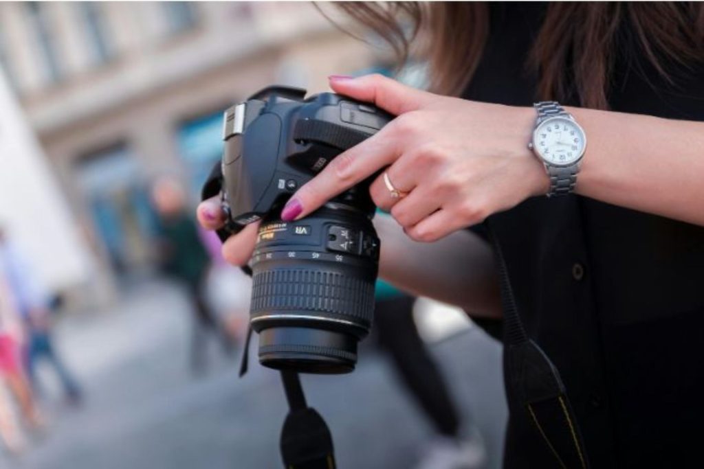 photographer looking at images on a camera