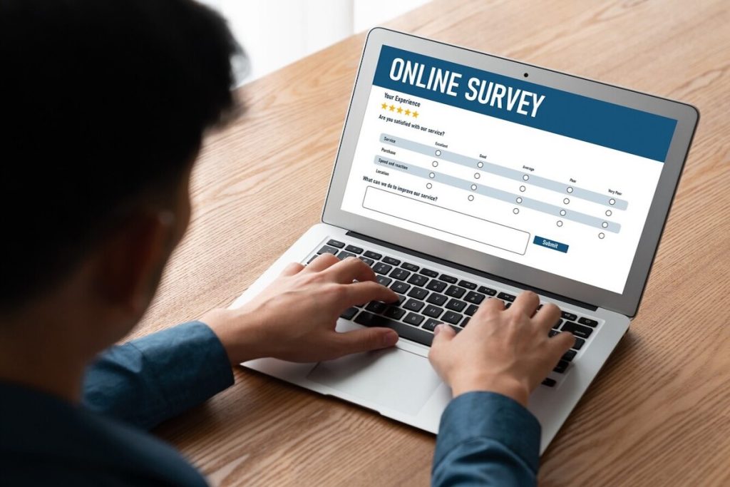 man taking an online survey on his laptop