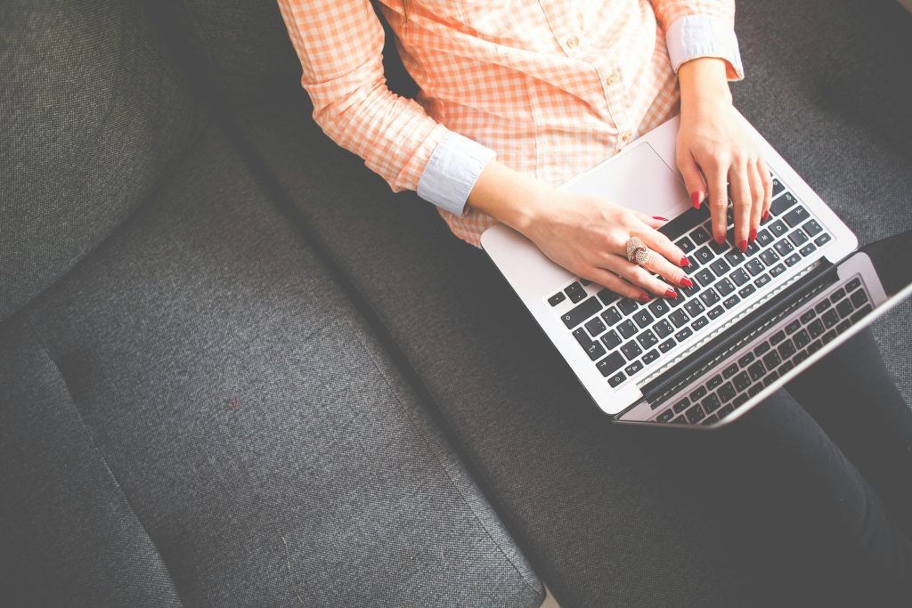 person working on laptop on couch
