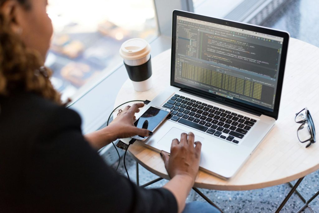 online work using a laptop and mobile phone