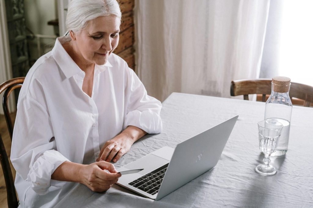 mature woman sitting at a laptop computer