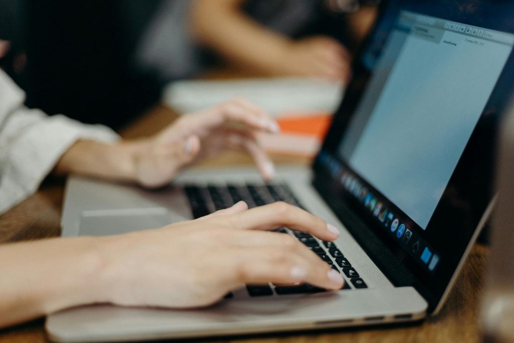 hands typing on a computer