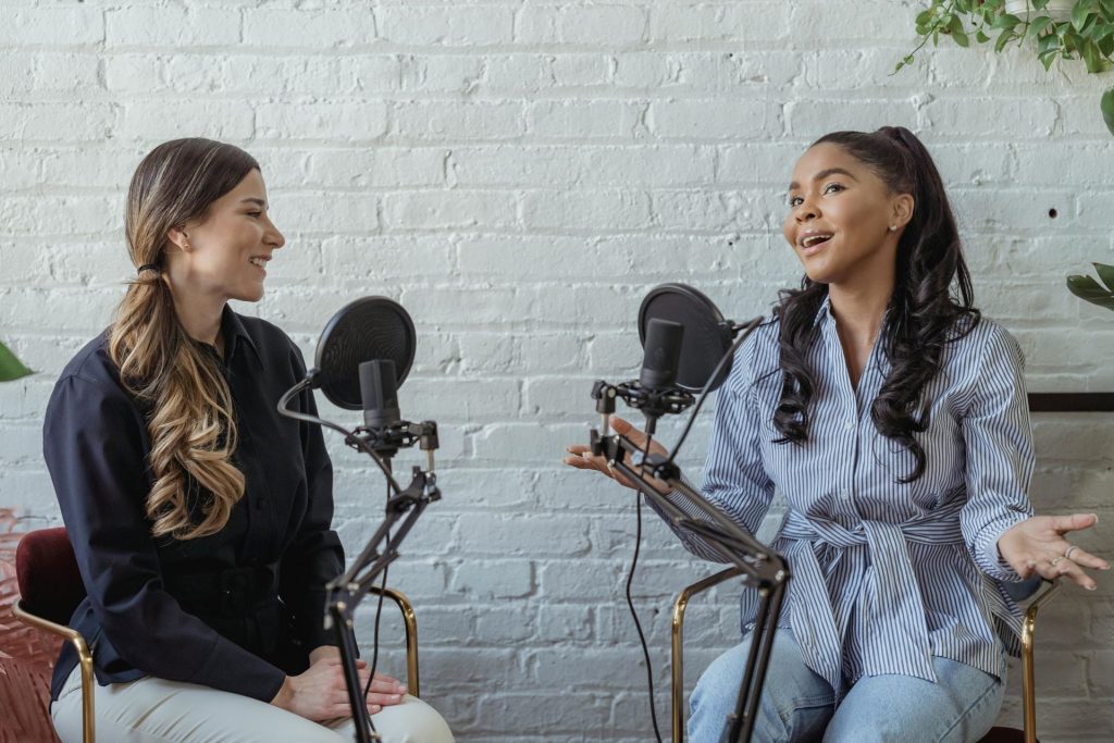 two women chatting on a podcast