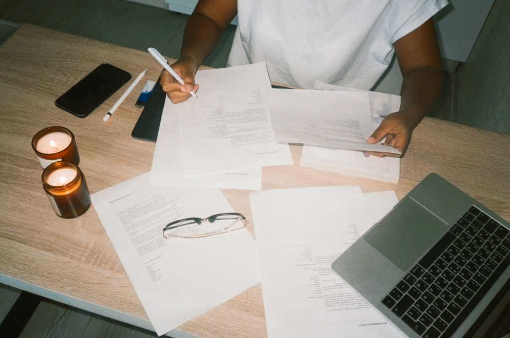 person at a desk proofreading papers