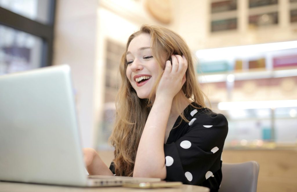 smiling young proofreader working on a laptop