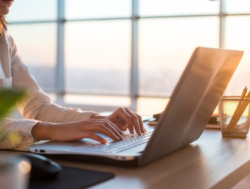 Adult businesswoman working at home using computer