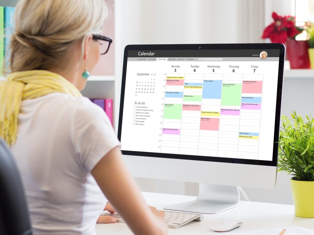 Woman using calendar app on computer