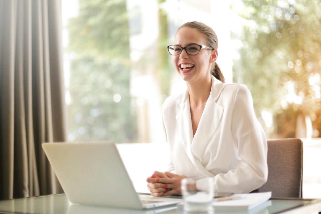 smiling woman working at laptop