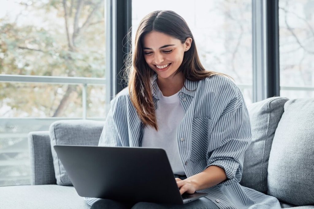 smiling woman working on laptop