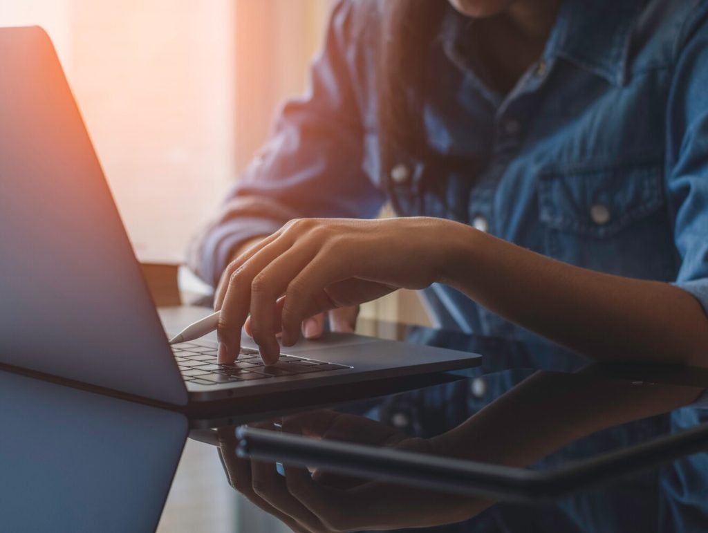 woman using laptop for proofreading