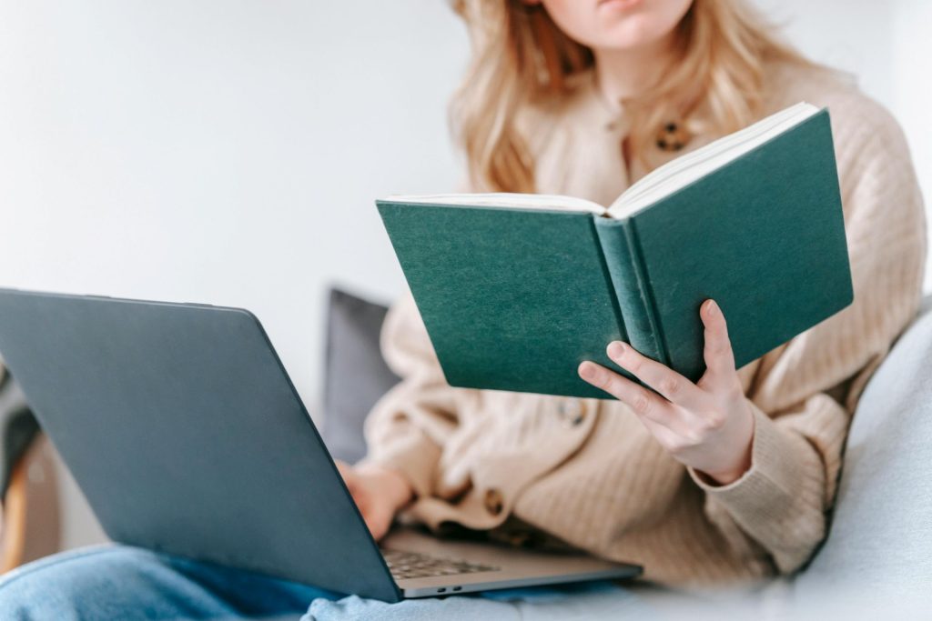woman with blond hair reading a book