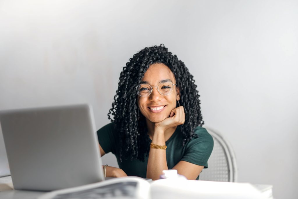 woman smiling behind a computer