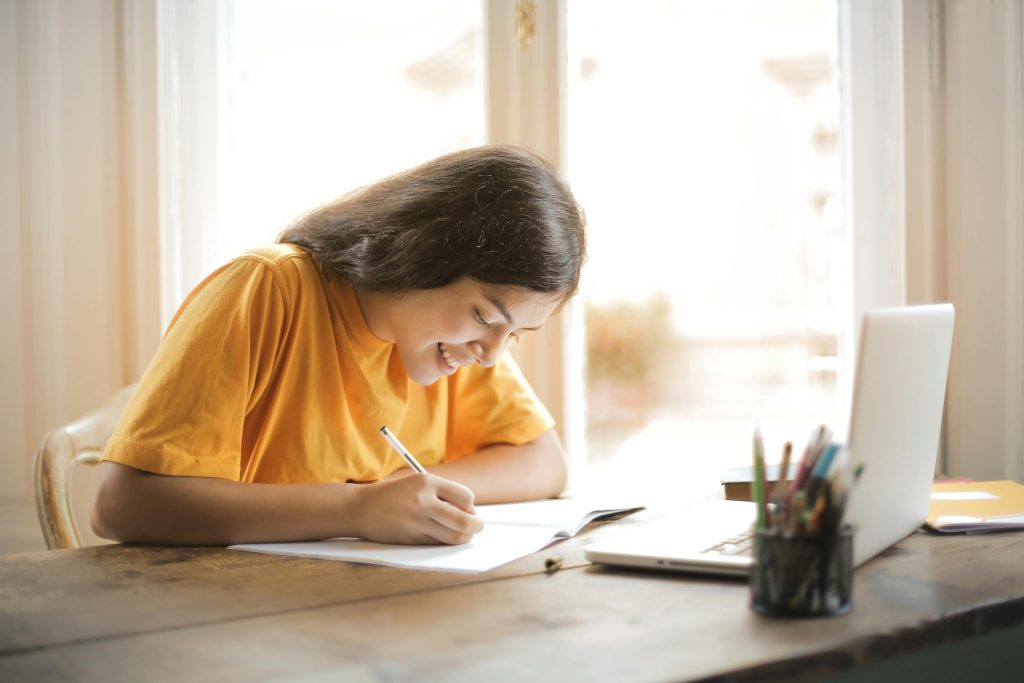 woman studying with notebook and laptop